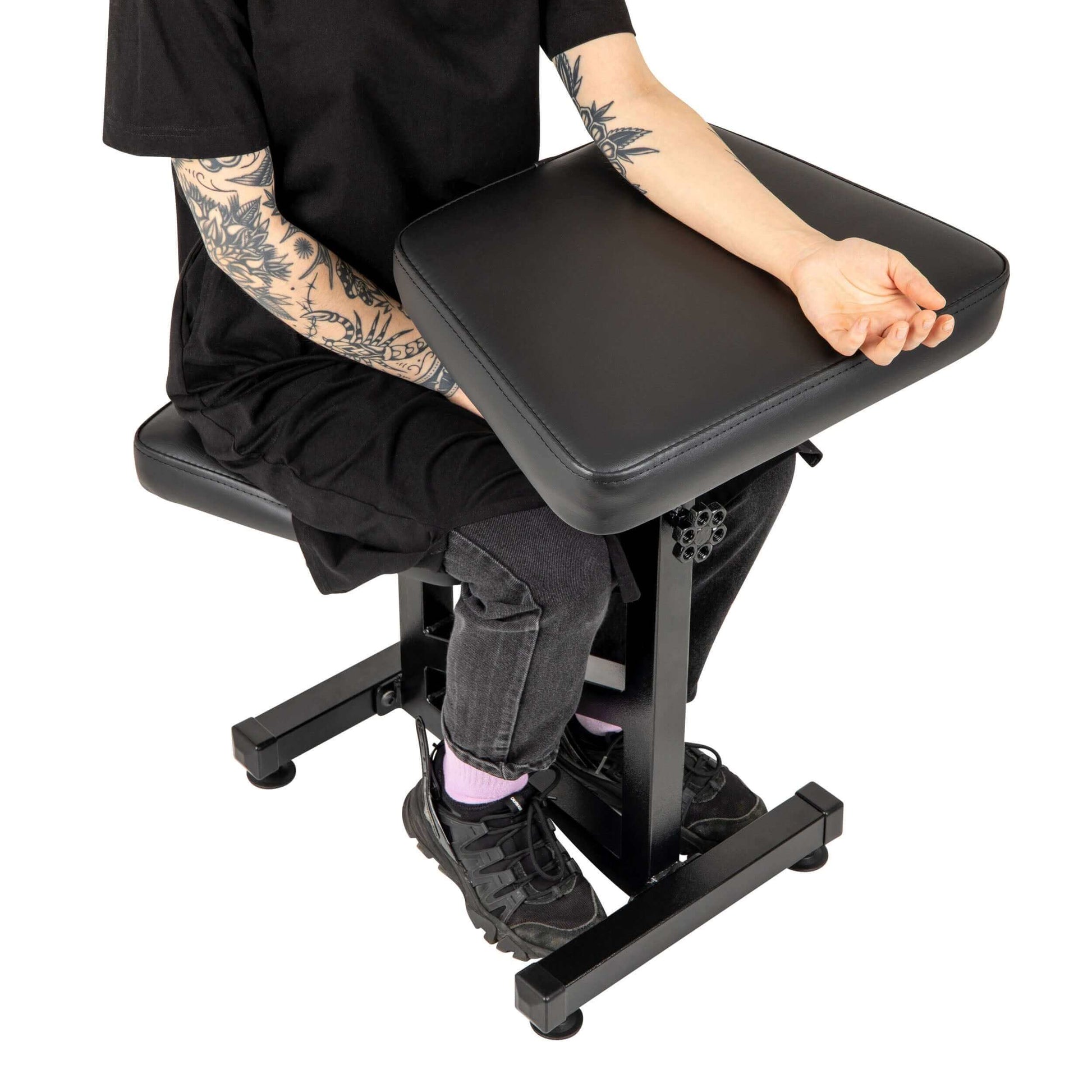 Tattoo artist using a premium multifunctional swivel chair with armrest, featuring adjustable height and tilt for optimal comfort.