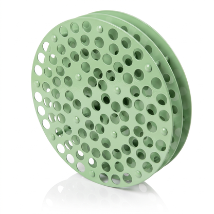 Pistachio green round Tattoo Ink Wheel - Rotary Rack by GG Workshop — stacked perforated discs, angled view
